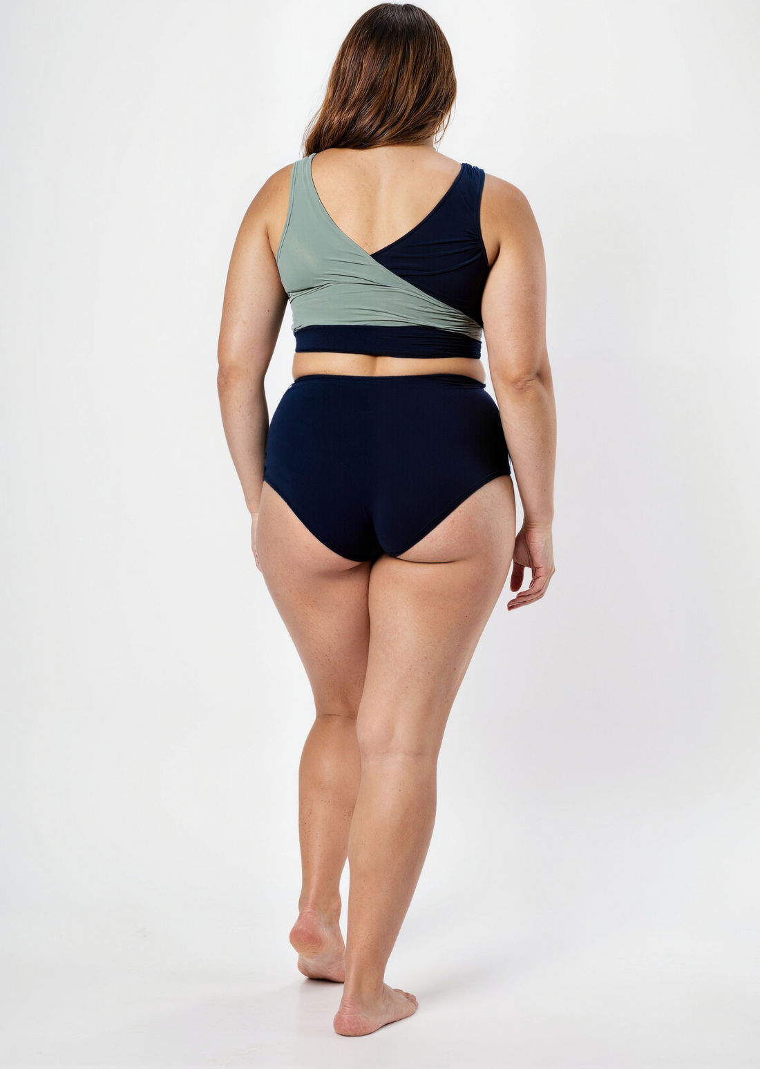 Woman wearing a two-tone bikini with a white background