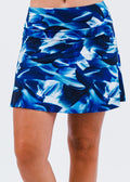 Blue floral patterned skirt worn by a person on a white background