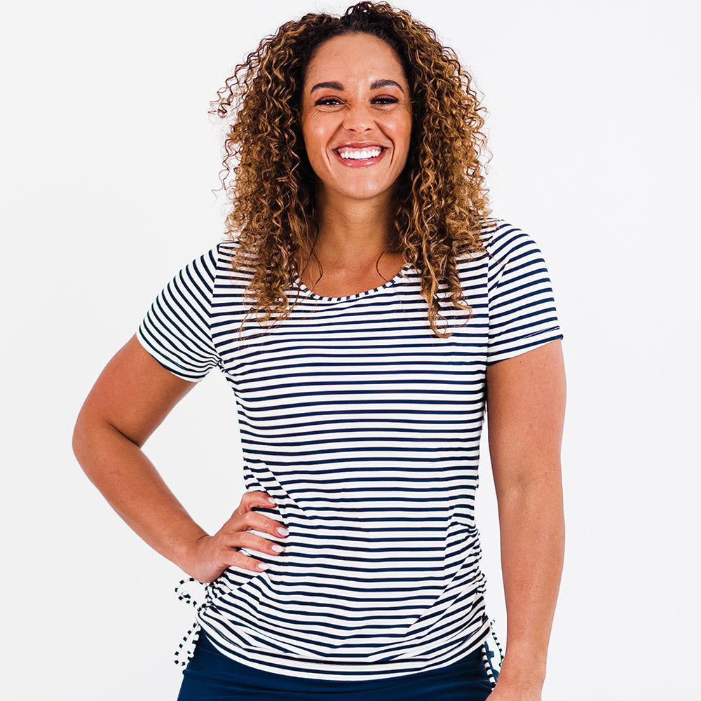 Short Sleeve Adele Swim Top in navy and white stripes modeled by a smiling woman showcasing supportive comfortable size inclusive swimwear designed for every body
