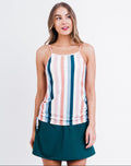 Woman wearing a striped tank top and green skirt on a white background
