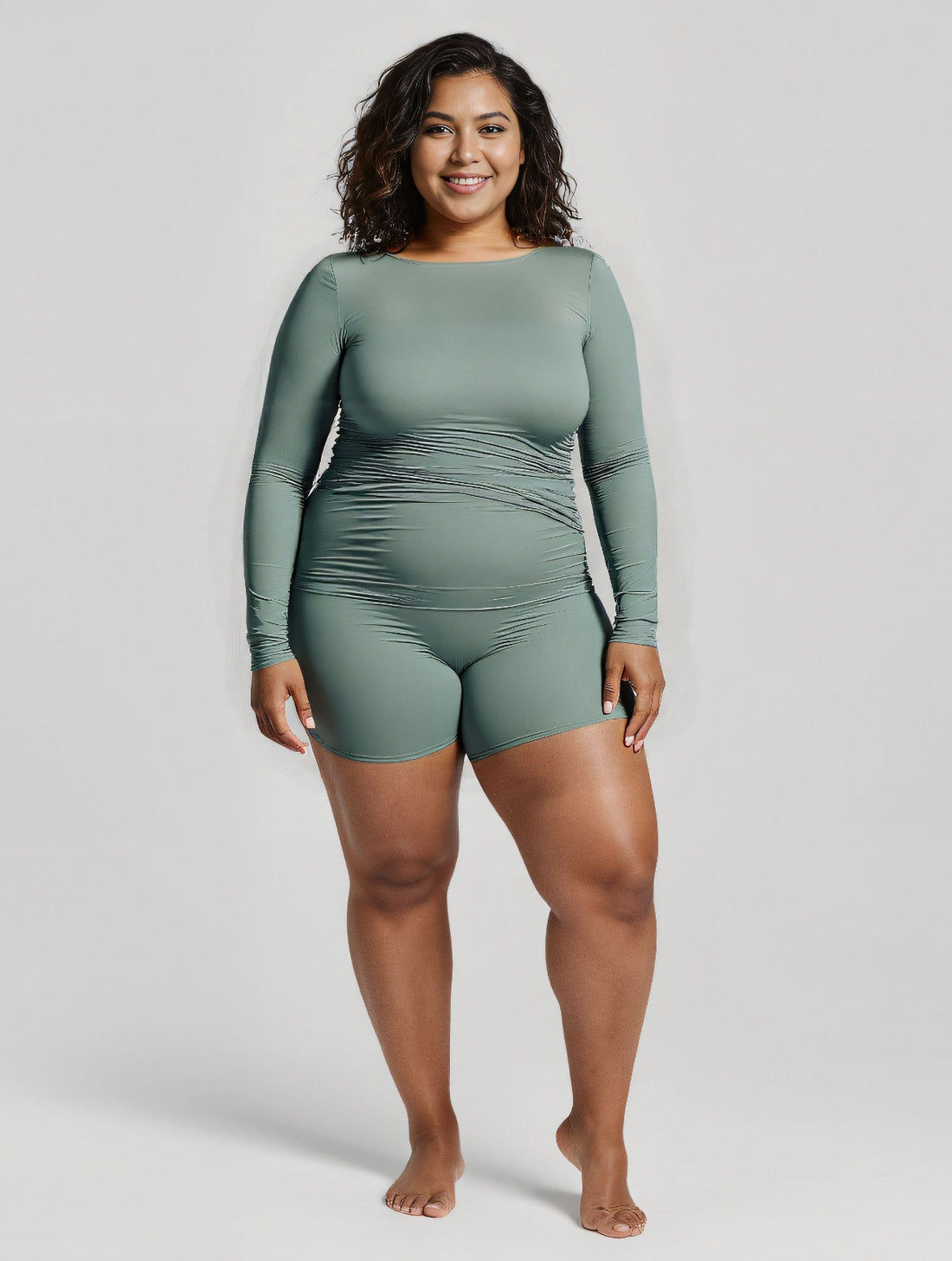 Avery 2 Piece Swim Set – Wrap Long Sleeve Top & Shorts | Plus Size shown on a woman at the beach as modest supportive size-inclusive swimwear designed for every body