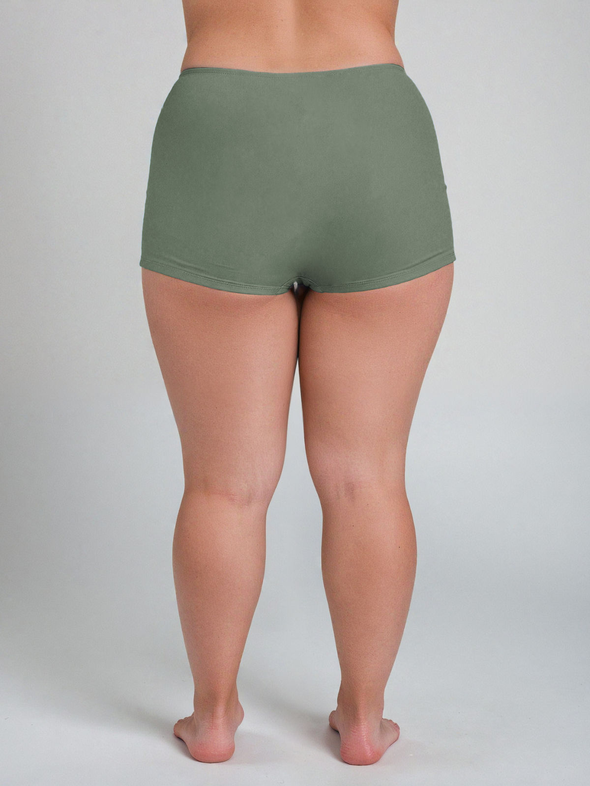 Green shorts worn by a woman on a plain background
