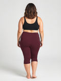 Woman shown from behind wearing deep wine-colored Capri Swim Leggings | Plus Size paired with a black supportive swim top, highlighting comfortable, size-inclusive, modest swimwear designed for every body.