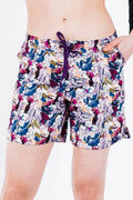 Colorful floral-patterned shorts worn by a person on a white background