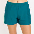 Front view of a model wearing dark jade Classic Fit Swim Shorts With Panty | Final Sale, featuring a size-inclusive, comfortable fit designed as modest and supportive swimwear for every body.