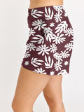 Maroon skirt with white floral pattern worn by a person on a white background