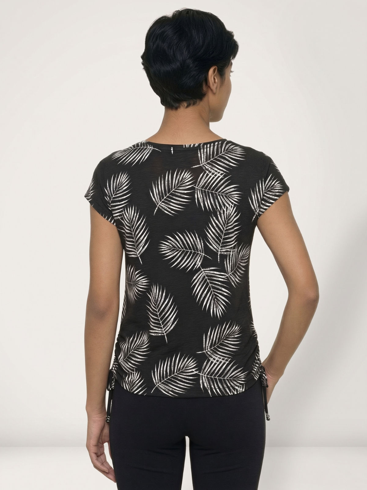 Daphne Loose Fit Swim Top in black with white leaf print shown from the back on a model offering modest size inclusive swimwear and a comfortable fit