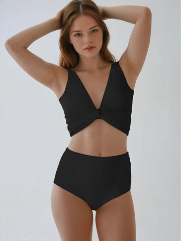 Woman wearing a black bikini against a plain background