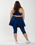 Flared Swim Skort With Capri Leggings | Plus Size shown from the back on a model in navy blue modest swimwear with a supportive fit for every body
