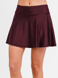 Maroon skirt worn by a person on a white background