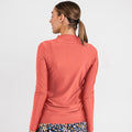 Woman wearing a rust-colored Half-Zip Nora Swim Top | Final Sale from the back, paired with floral swim bottoms, showcasing size-inclusive, modest, supportive swimwear with a comfortable fit, swimwear designed for every body.