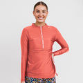 Smiling woman wearing a rust-colored Half-Zip Nora Swim Top | Final Sale with long sleeves and a front zipper, styled with floral swim bottoms, showcasing size-inclusive, modest, supportive swimwear designed for every body with a comfortable fit.
