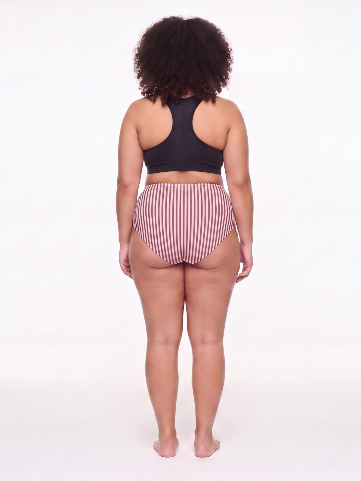 Rear view of a model wearing the High Waisted Full Coverage Bikini Bottom | Plus Size, featuring striped fabric, a high rise, and full coverage for a comfortable fit.
