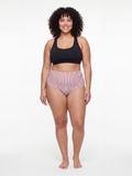 Model wearing High Waisted Full Coverage Bikini Bottom | Plus Size with striped fabric, paired with a black swim top for a modest, supportive, comfortable fit.