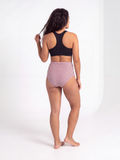 High Waisted Full Coverage Bikini Bottom in red and white stripes modeled from the back with a high rise fit and comfortable coverage for modest swimwear designed for every body