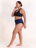 High Waisted Full Coverage Bikini Bottom | Plus Size shown on a smiling model in navy swimwear with a supportive high waisted fit for every body