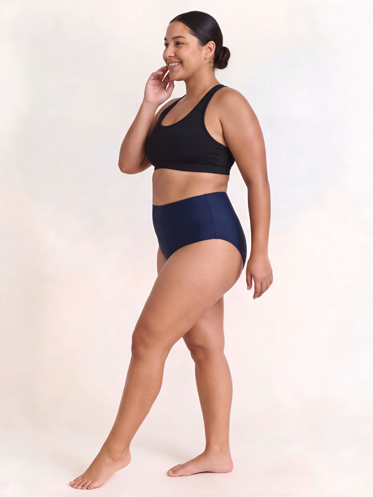 High Waisted Full Coverage Bikini Bottom | Plus Size shown on a smiling model in navy swimwear with a supportive high waisted fit for every body