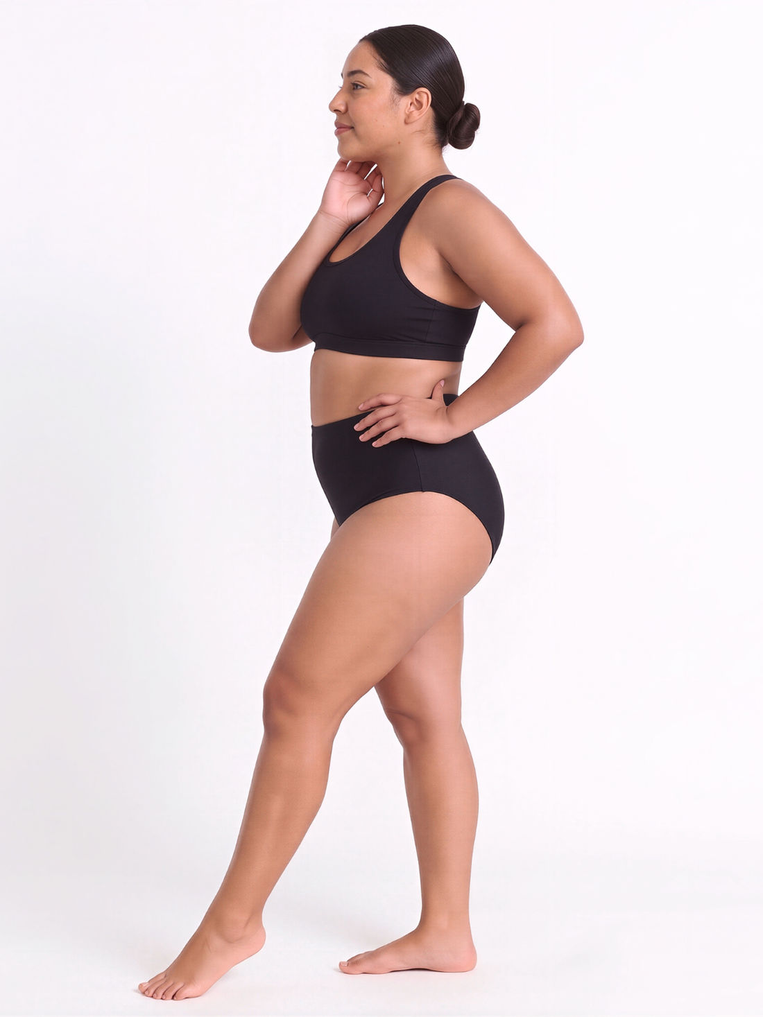 High Waisted Full Coverage Bikini Bottom | Plus Size worn by a woman walking through shallow beach water in supportive size-inclusive swimwear designed for every body