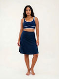 Woman wearing navy Knee Length Swim Skort With Bike Shorts and a matching supportive swim top for a comfortable fit and modest swimwear designed for every body