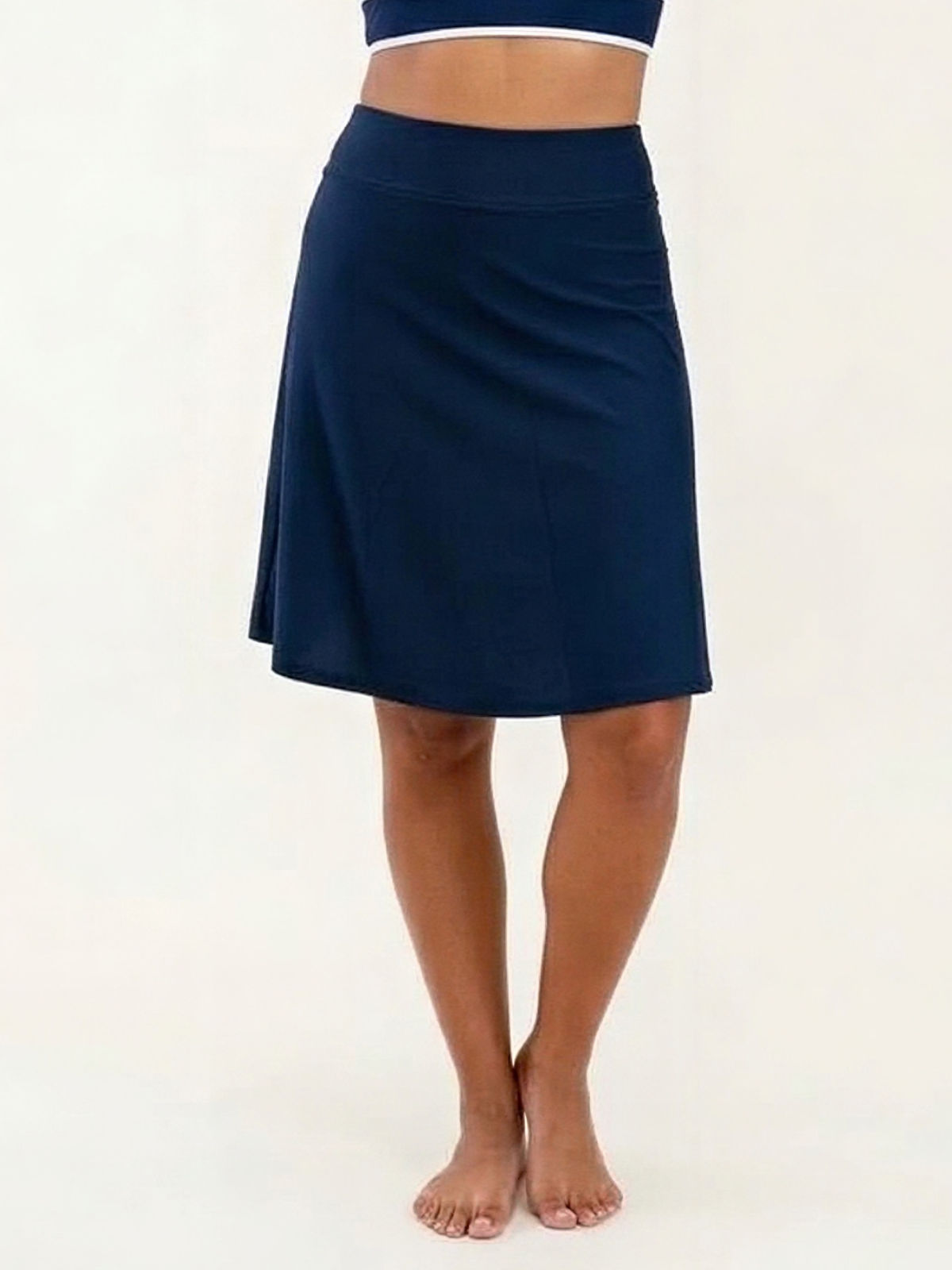 Knee Length Swim Skort With Bike Shorts in navy shown on a model with a modest knee length design and comfortable supportive fit for every body