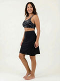 Model wearing Knee Length Swim Skort With Bike Shorts in black modest supportive comfortable size inclusive swimwear designed for every body