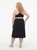 Back view of a woman wearing Long Swim Skort With Capri Leggings | Plus Size in black with a modest comfortable fit and swimwear designed for every body