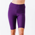 Close-up of a person wearing eggplant-colored Long Bike Swim Shorts, featuring a comfortable fit with supportive, size-inclusive, modest swimwear designed for every body.