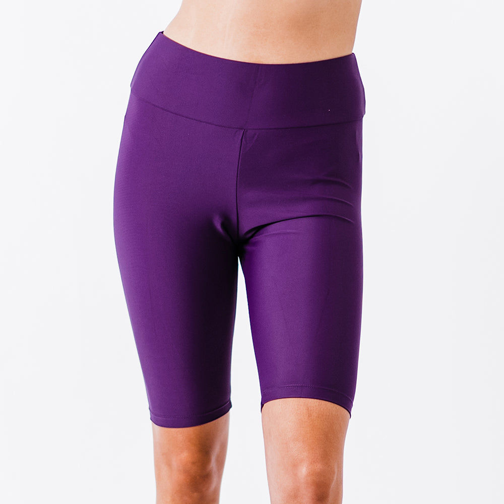 Close-up of a person wearing eggplant-colored Long Bike Swim Shorts, featuring a comfortable fit with supportive, size-inclusive, modest swimwear designed for every body.