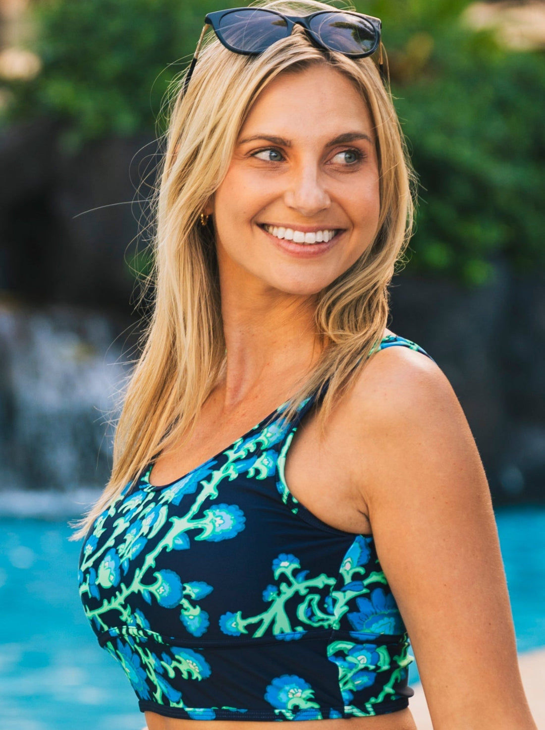 Woman wearing a purple Longline Swim Bra with abstract white line patterns, paired with matching swim shorts, showcasing supportive swimwear designed for every body with a comfortable fit.