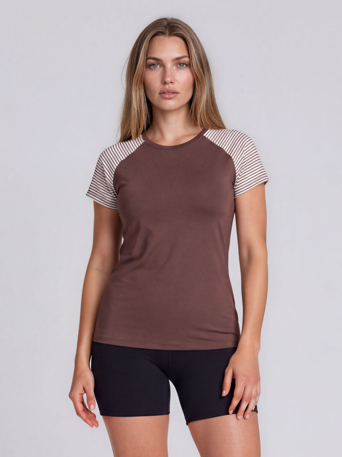 Loose Fit Adele Swim Top in brown with striped short sleeves modeled by a woman as supportive and comfortable swimwear designed for every body