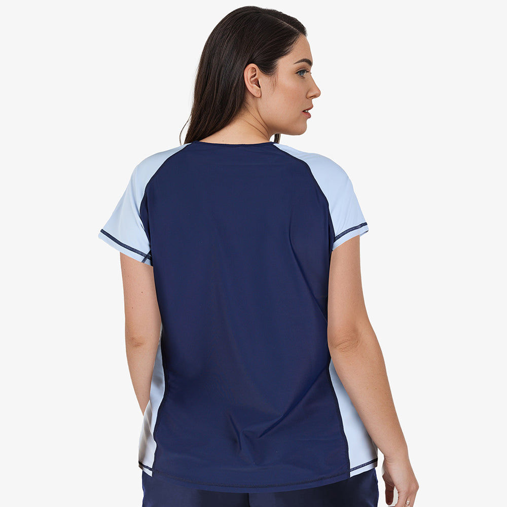 Woman wearing size-inclusive Loose Fit Adele Swim Top | Final Sale in navy and dusty blue with a comfortable fit, designed as modest, supportive swimwear for every body.