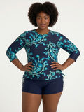 Margaux Swim Top | Plus Size modeled by a woman in patterned long sleeve swimwear with a high neckline and comfortable coverage for every body