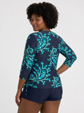 Margaux Swim Top | Plus Size modeled on a woman in a patterned long sleeve swim top with swim shorts showcasing modest size inclusive swimwear for every body