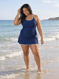 Maya Two-Toned Tankini Swim Top With Removable Cups | Plus Size navy tankini top modeled at the beach showcasing supportive size-inclusive swimwear designed for every body