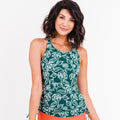 Woman wearing a green floral tank top on a white background