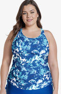 Woman wearing a blue and white patterned tank top on a white background