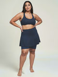 Woman wearing a navy blue athletic outfit on a plain background