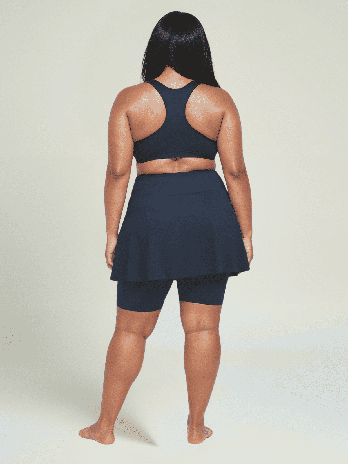 Person wearing a navy blue athletic outfit on a light background