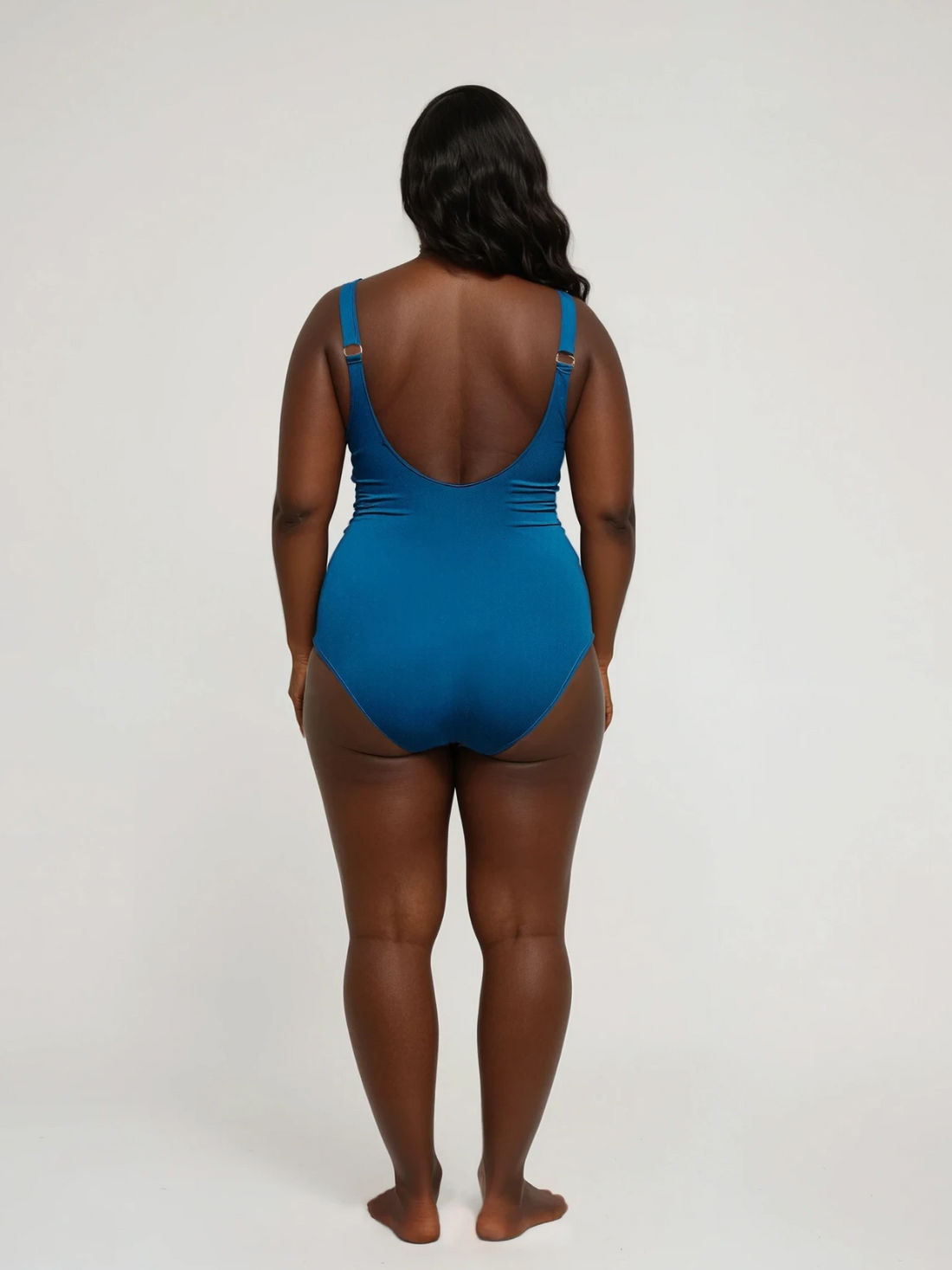 Woman wearing a blue swimsuit on a white background