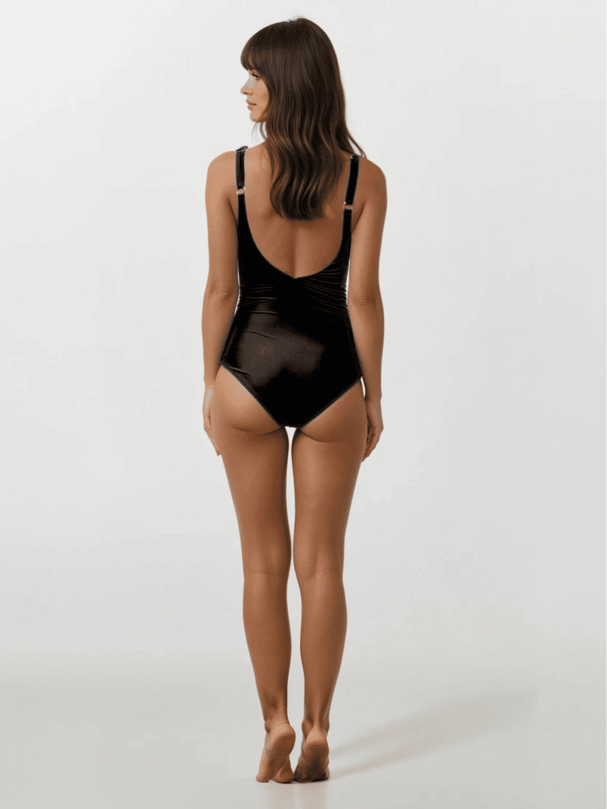 Woman wearing a black swimsuit on a white background