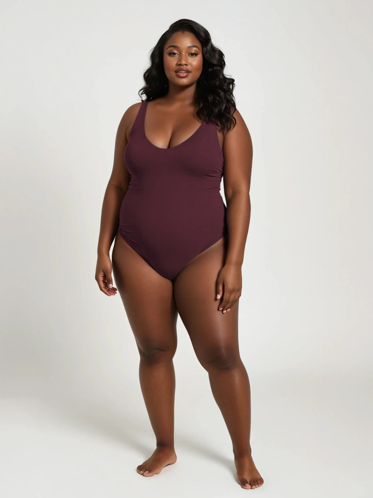 Woman wearing a burgundy swimsuit on a white background