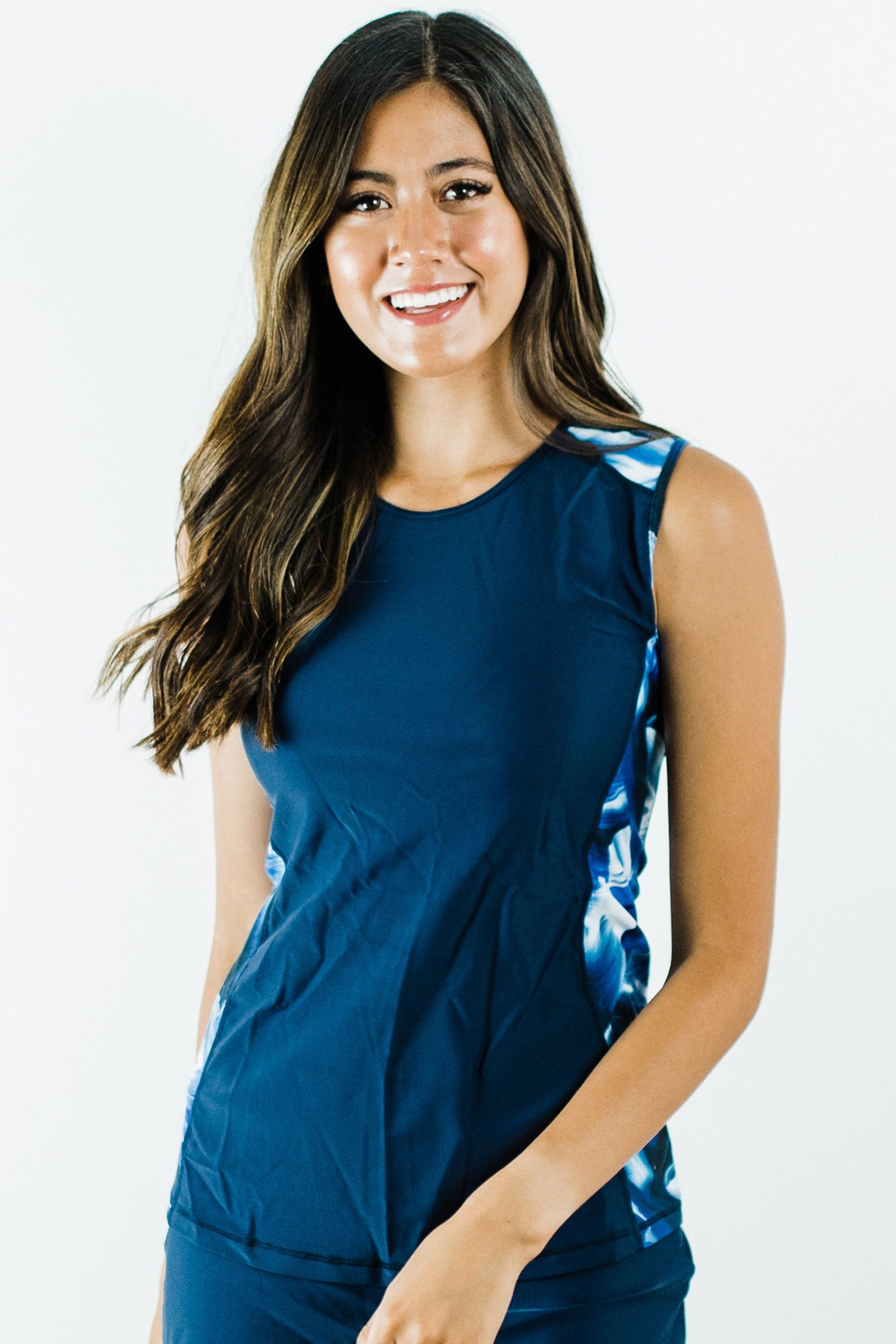 Young woman smiling wearing a navy and wave patterned Loose Fit Maya Swim Top | Final Sale, showcasing supportive, comfortable, size-inclusive swimwear designed for every body.