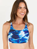 Woman wearing a blue floral bikini top on a white background