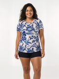 Short Sleeve Adele Swim Top | Plus Size worn by a smiling woman in a blue floral print. Modest supportive and comfortable size-inclusive swimwear designed for every body.