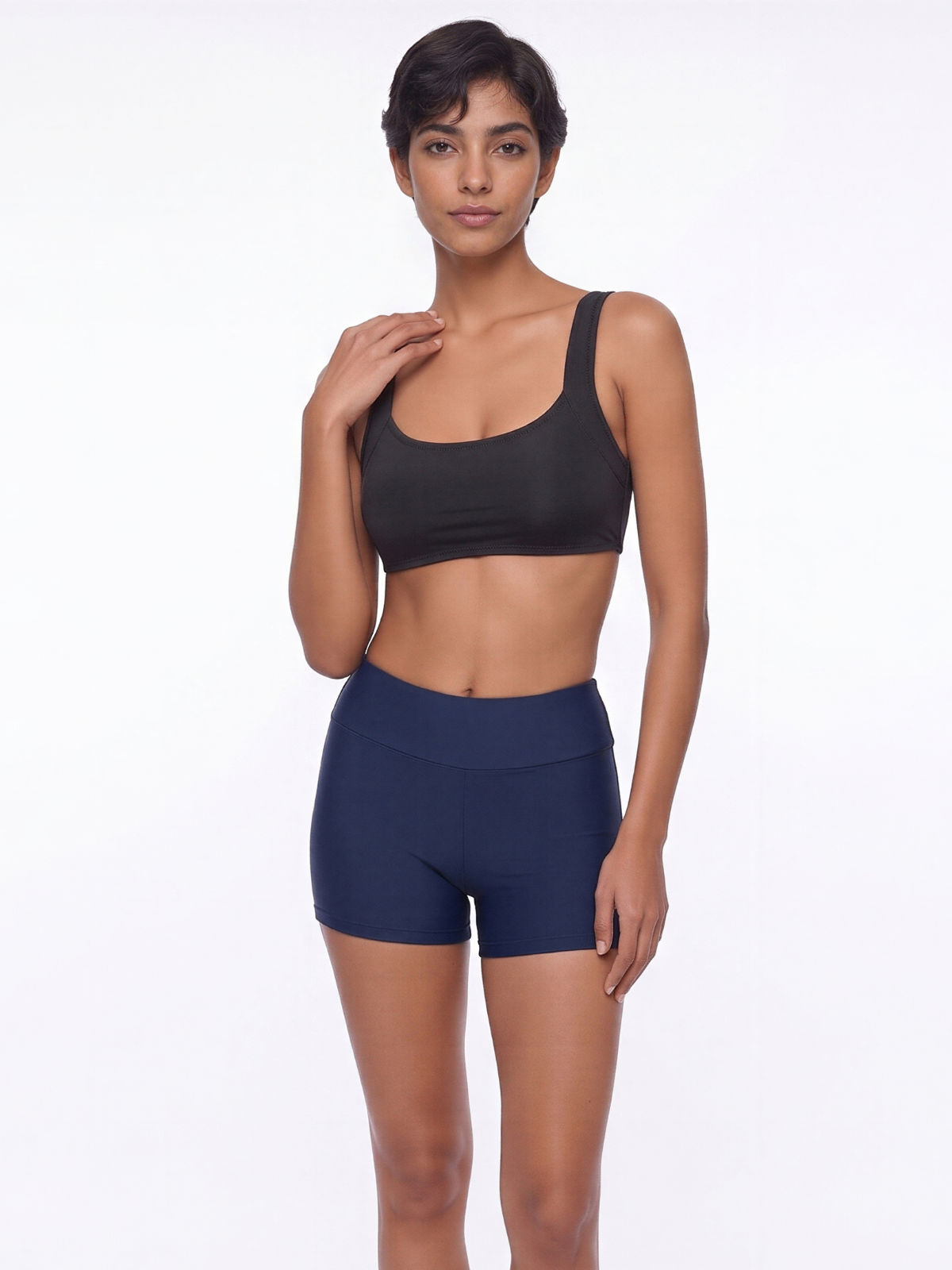 Sienna Swim Bra in black styled with navy swim shorts on a model showcasing supportive swimwear with a comfortable fit for every body