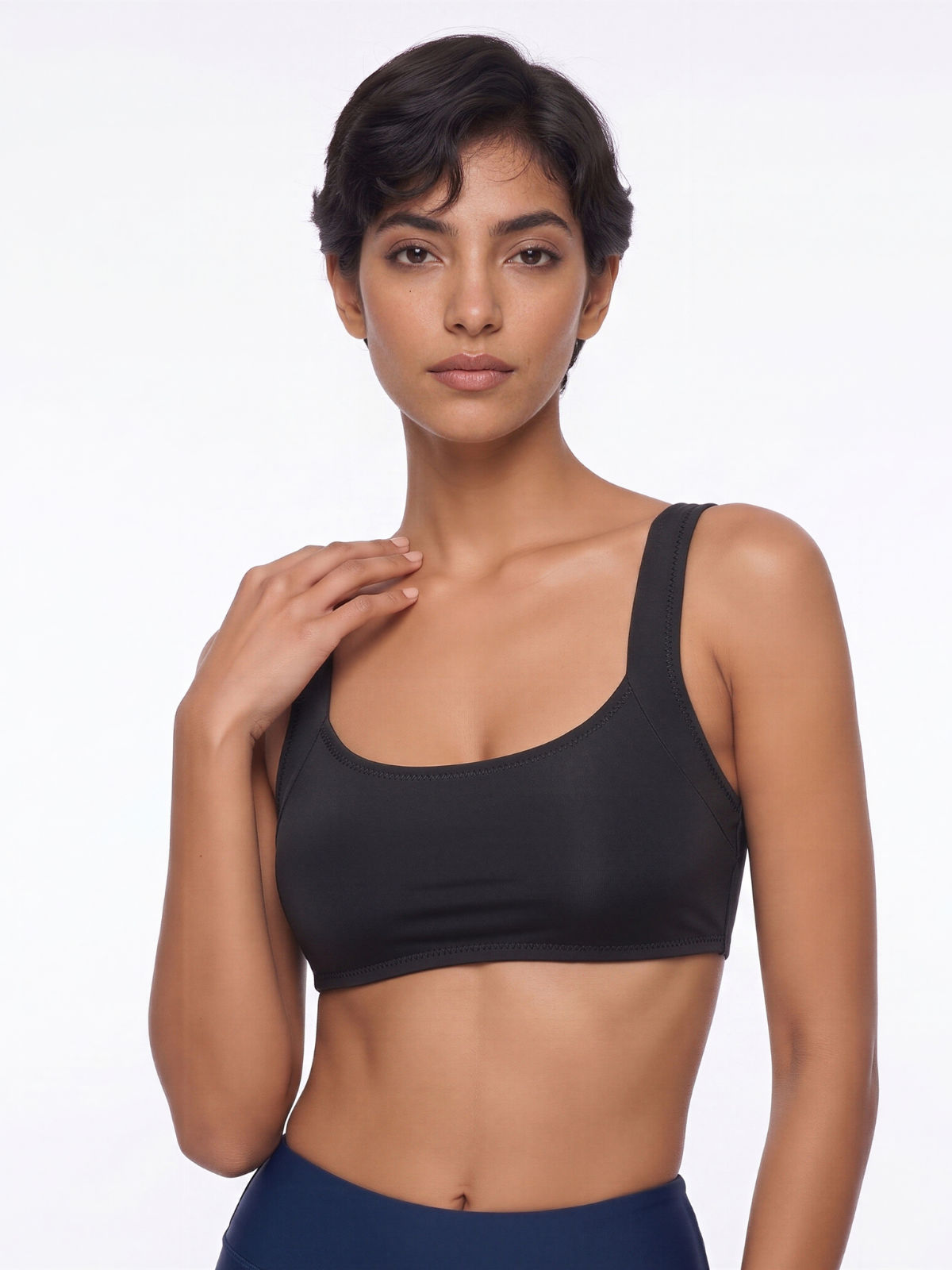 Sienna Swim Bra in black worn with navy swim bottoms on a model showcasing supportive size inclusive swimwear with a comfortable fit for every body