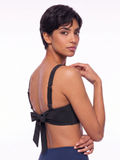 Sienna Swim Bra in black with adjustable straps and a tie back modeled from behind for supportive comfortable swimwear designed for every body