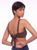 Sienna Swim Bra in brown shown from the back on a model with adjustable straps and a tie closure supportive comfortable size inclusive swimwear for every body