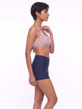 Sienna Swim Bra in a striped design modeled with navy high waisted swim bottoms showcasing modest supportive swimwear designed for every body