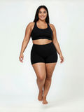 Swim Shorts | Plus Size shown on a smiling model in black swim shorts and a matching top for comfortable size inclusive swimwear designed for every body